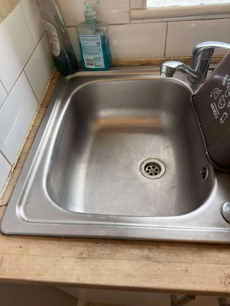 Stainless steel kitchen sink with mixer tap